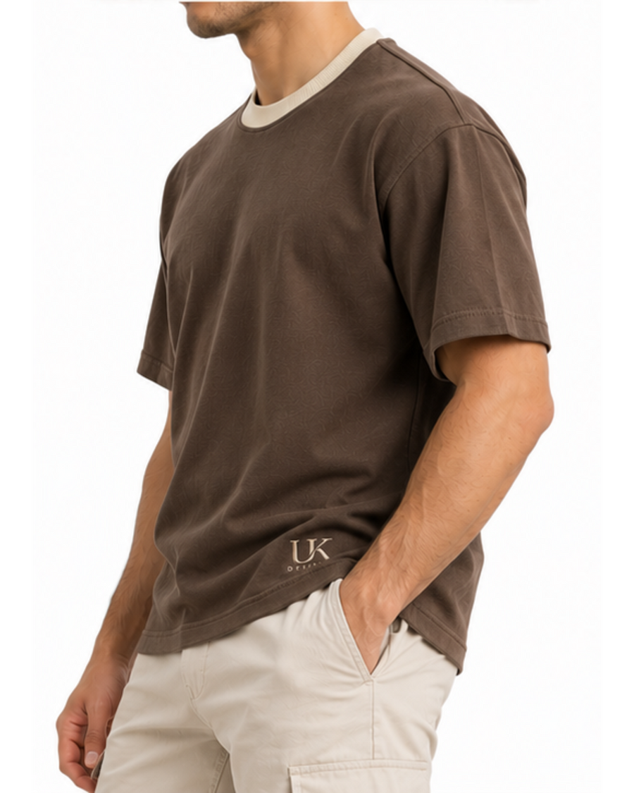 Side view of the boxy T-shirt on a model with sand trousers