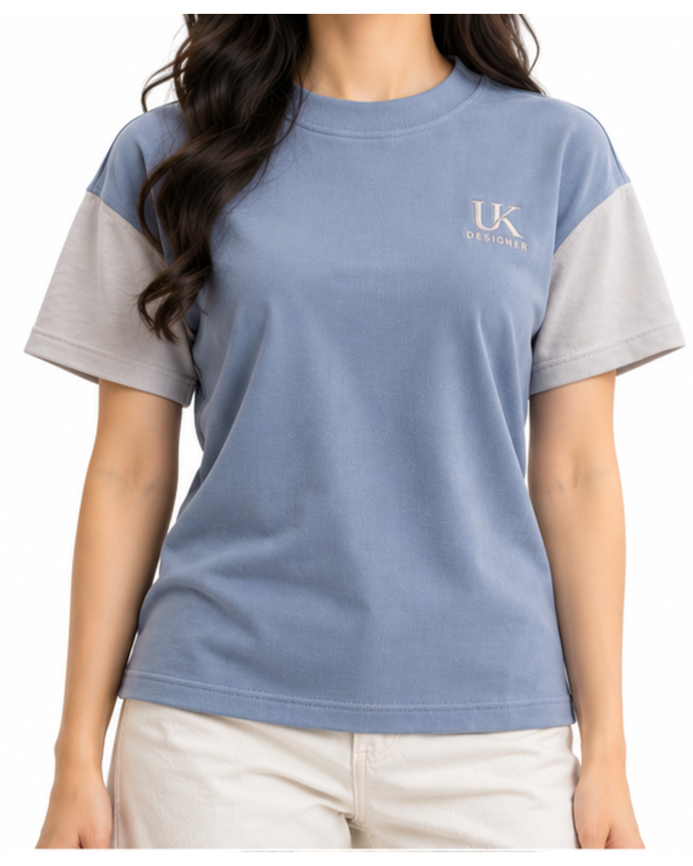 Model wearing the glacier blue relaxed T-shirt with cream trousers